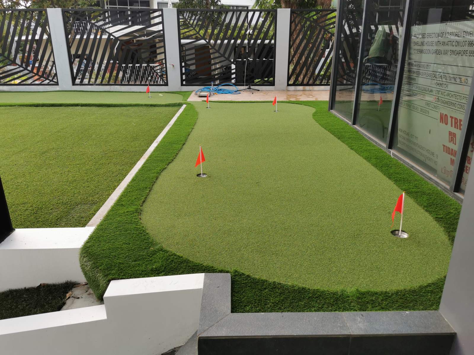 Rooftop lawn with a reflecting pool and timber deck at Serangoon Garden Way